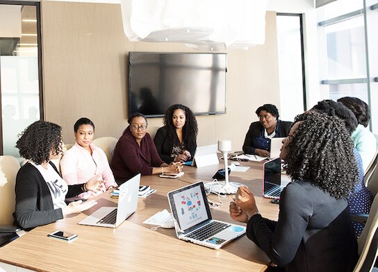 Women discussing ideas at workshop.