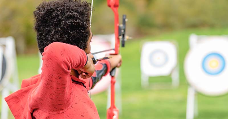 Young man practicing archery