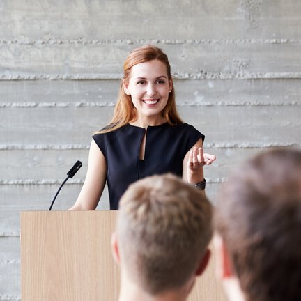 Woman presenting at event.